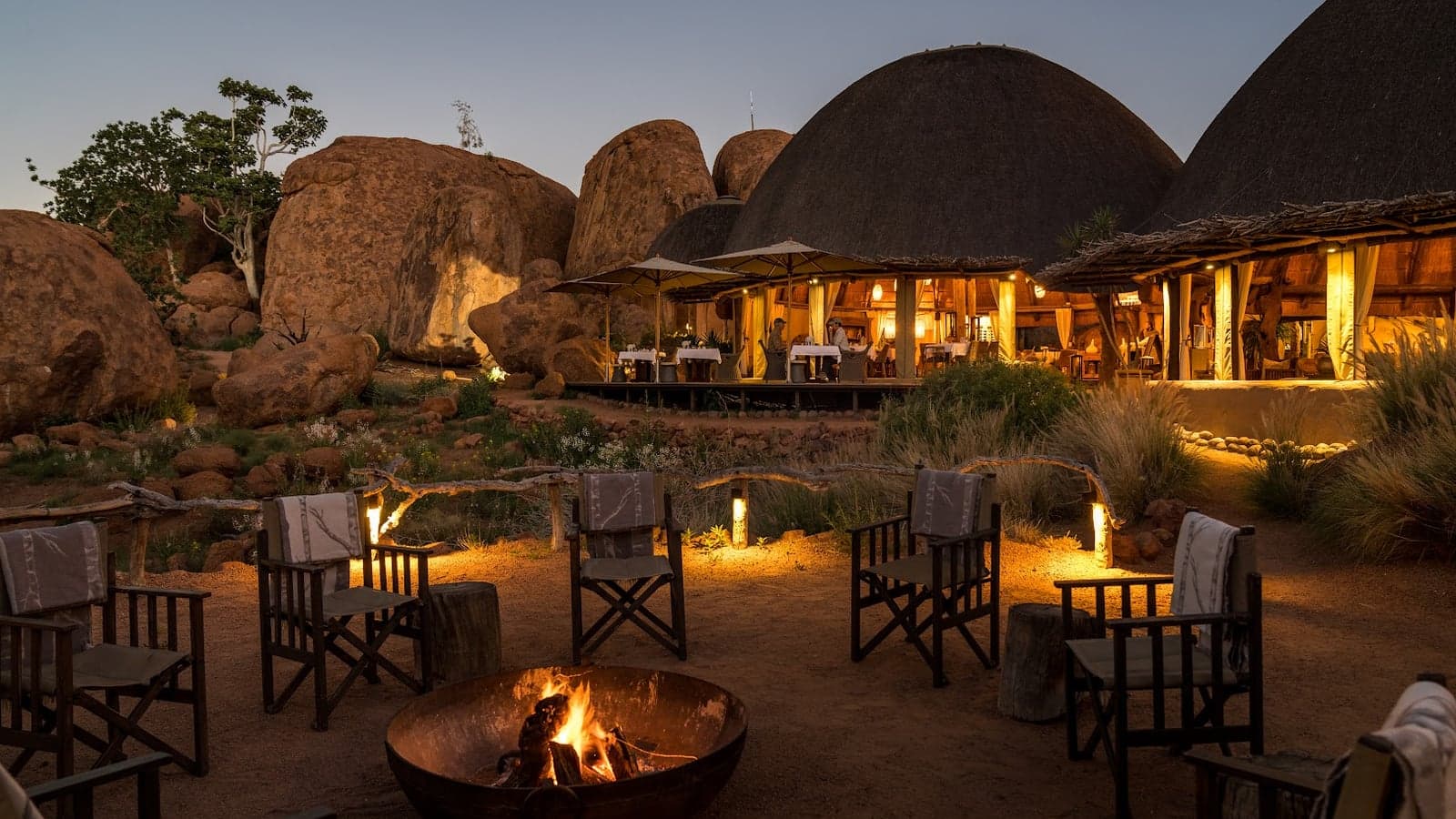 Thatched rooms set among giant red granite boulders at Mowani Mountain Camp