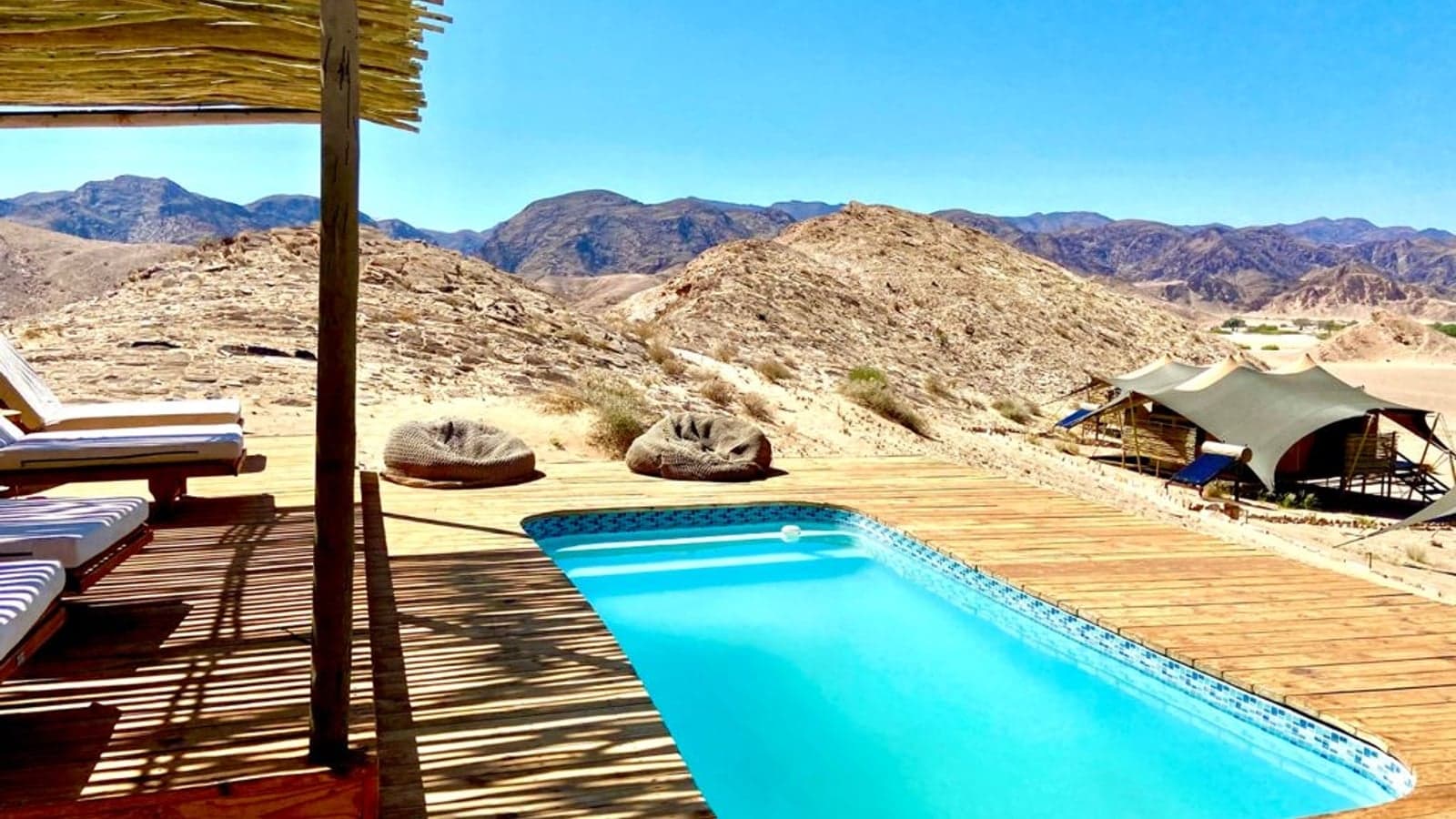 The pool deck overlooking the Hoanib Valley mountains at Hoanib Valley Camp