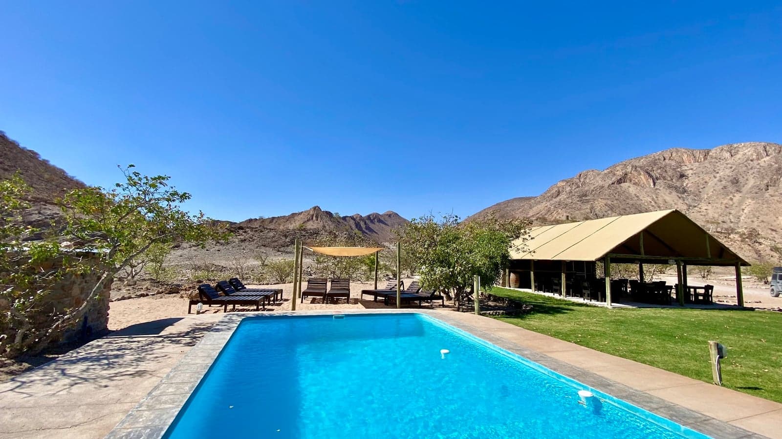 The pool at Khowarib Lodge with the Khowarib Gorge mountains behind