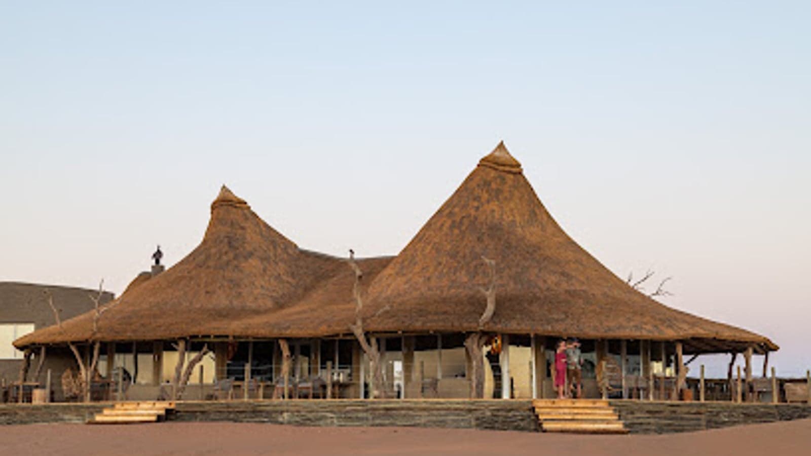Thatched chalets on red desert terrain at Kulala Desert Lodge, Sossusvlei