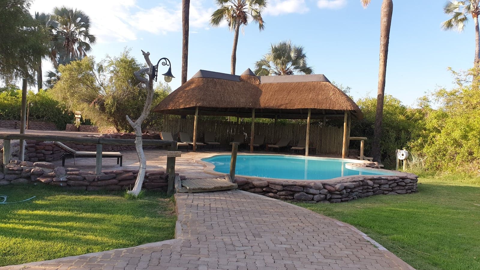 Thatched chalets and pool at Palmwag Lodge, gateway to the Palmwag Concession
