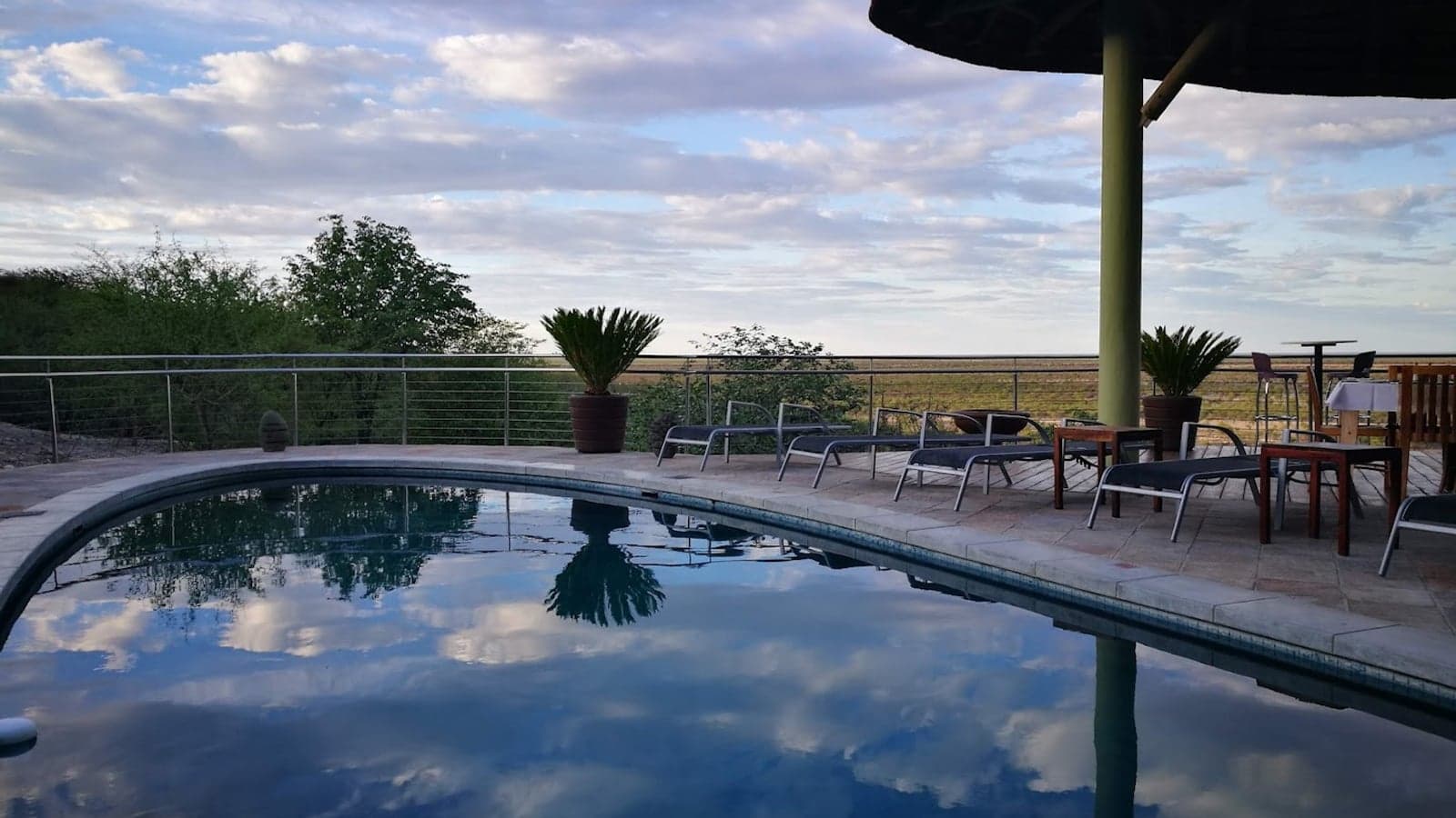 The pool deck at Safarihoek Lodge overlooking the surrounding plains at dusk