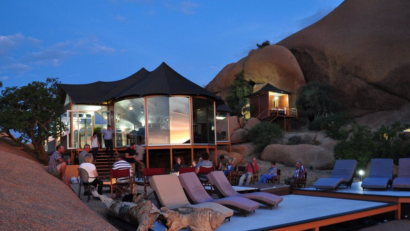 Elevated chalets among the granite domes of Spitzkoppen Lodge at dusk