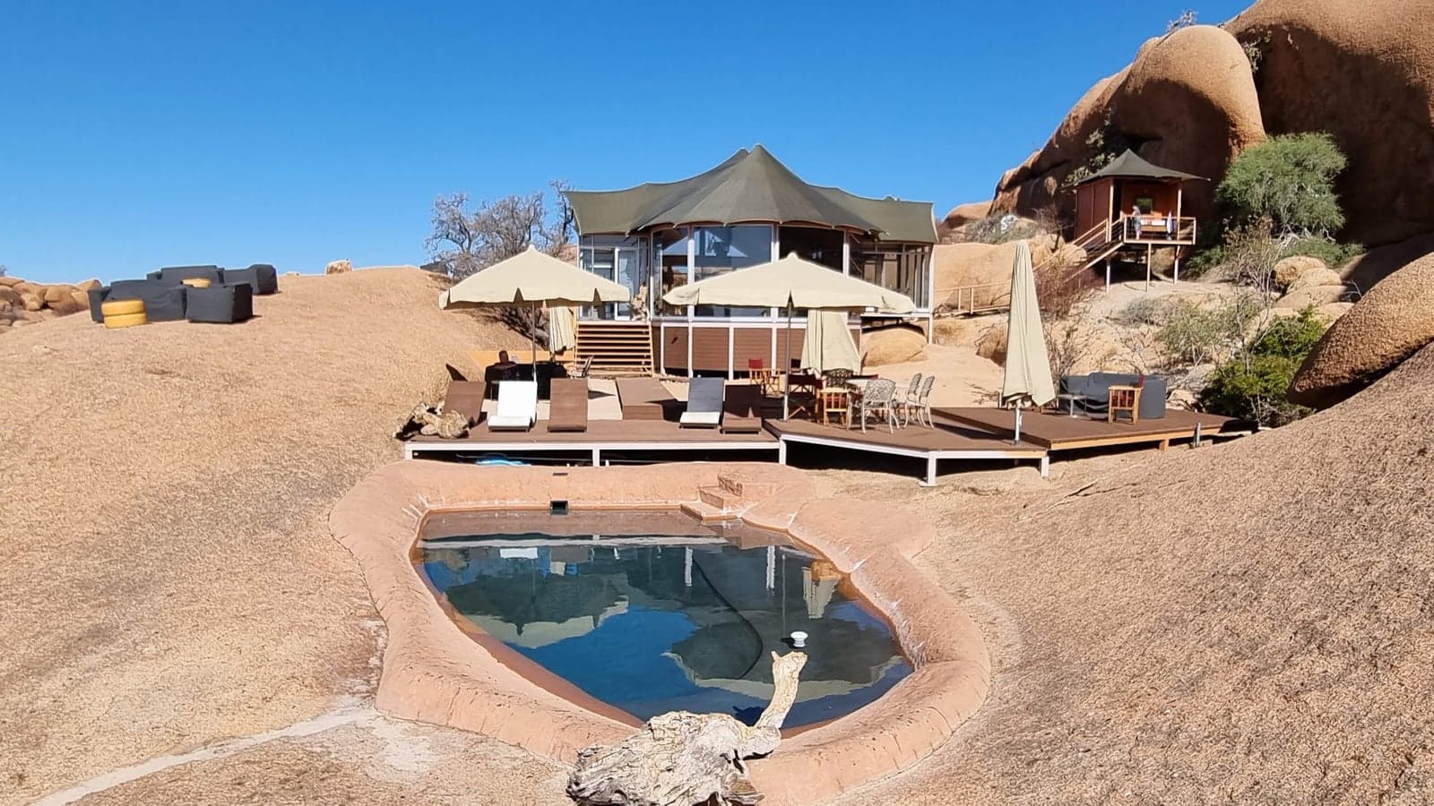 The rock-set pool and main lodge among the granite domes of Spitzkoppen Lodge