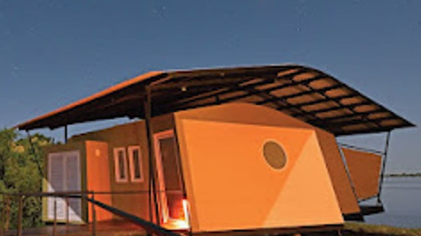 Brick-and-thatch bungalows on the Zambezi River at Zambezi Mubala Lodge